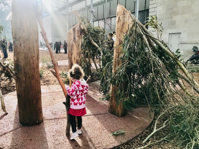 child building with logs and brances