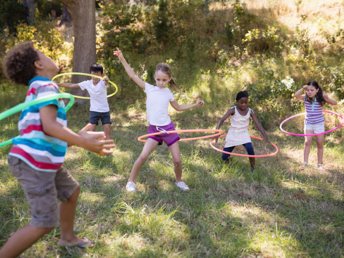 kids doing hula hoop probably at summer camp