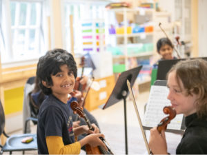 students with violins string instruments