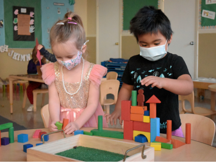 two kids building with blocks