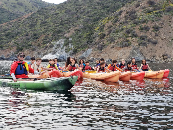 lots of teens in kayaks