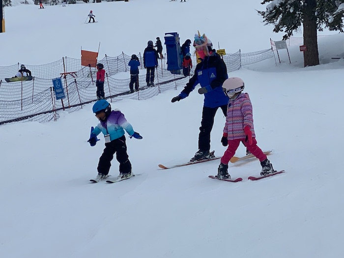 girls skiing with instructor