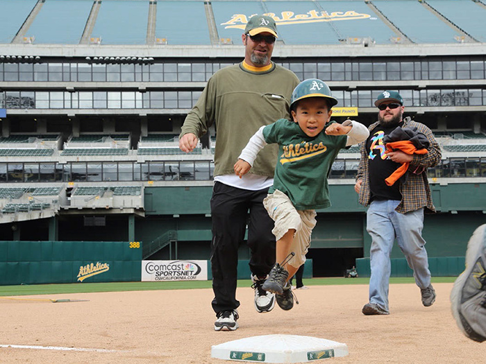 child runs around major league bases