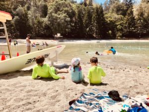 kids sitting on beach