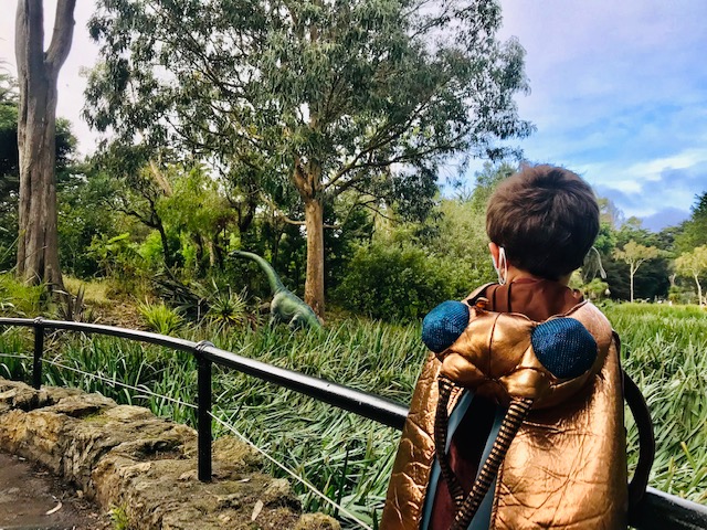 child looking at dinosaur