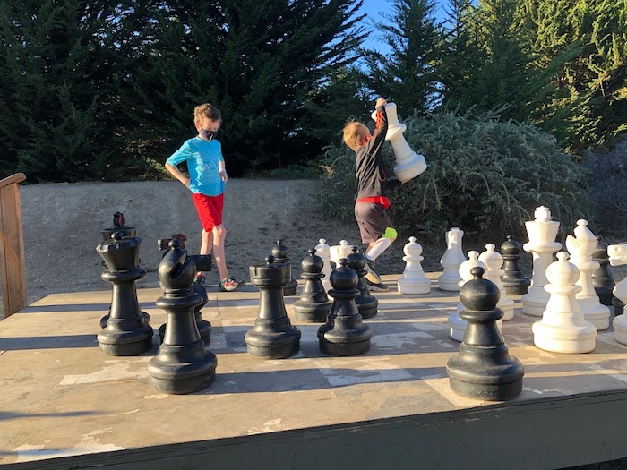 two kids playing giant chess