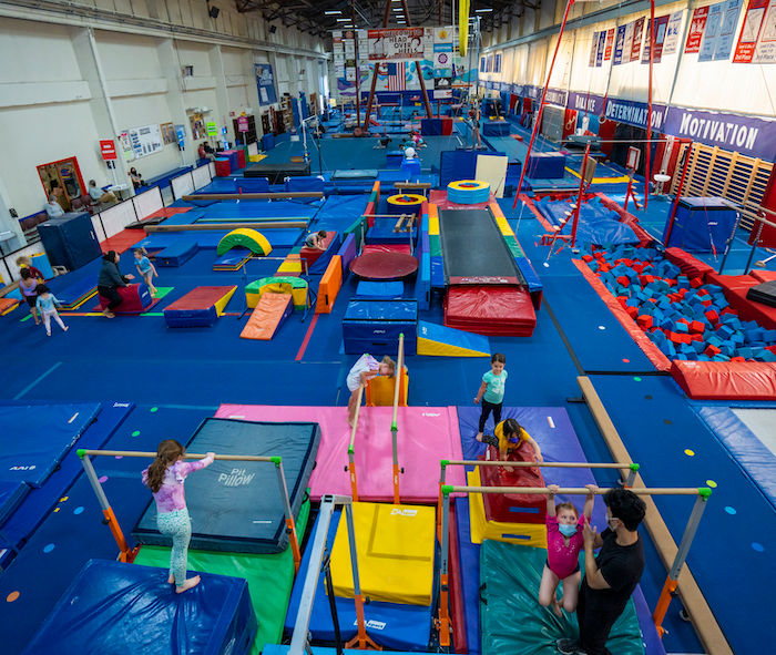 large gymnastics gym with equipment and children