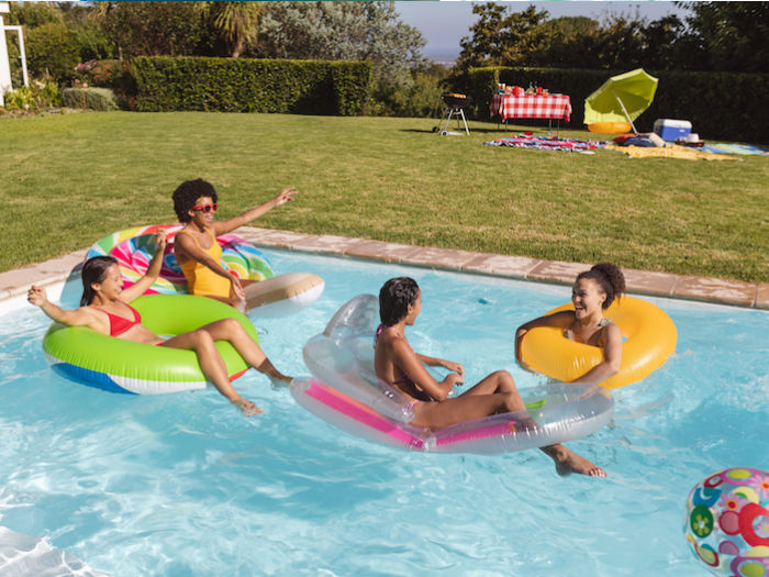 pool party with friends on floating tubes