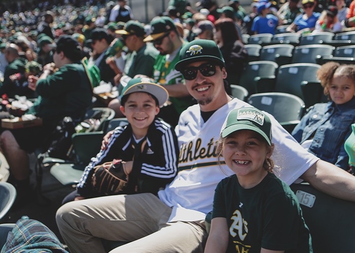 Smiling family at the Oakland A's baseball game