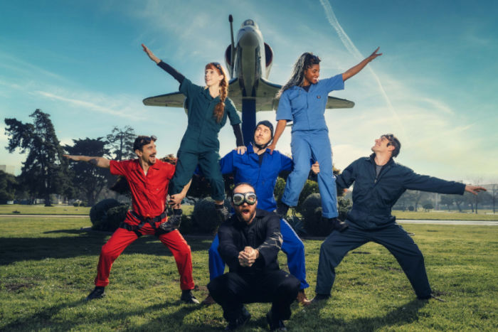 human pyramid made of people dressed as pilots