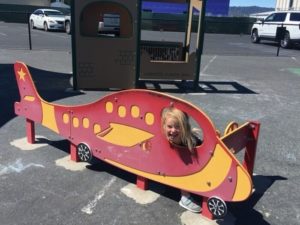 Child plays in plane play structure