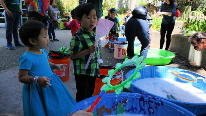 little kids blowing bubbles