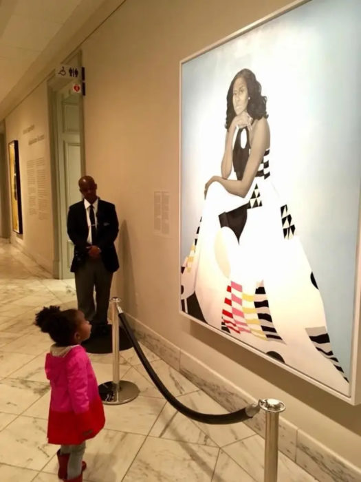 large painting of michelle obama small girl observes