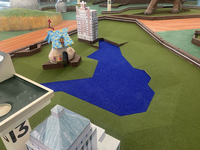 subpar indoor mini golf hole 13 of lake merritt features the fairyland shoe and glimpses of other buildings
