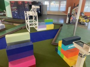 subpar indoor mini golf hole 15 of port of oakland with cool containers and dock loaders
