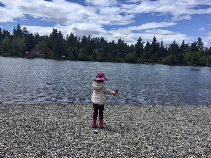 Vacation Inspiration: Sunriver & Bend, Oregon 1 Child throws rocks into Deschutes River