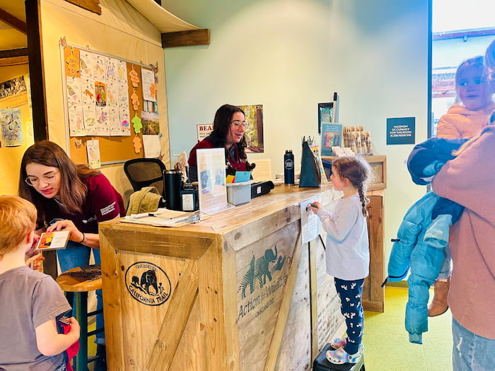 child talking to zoo staff 
