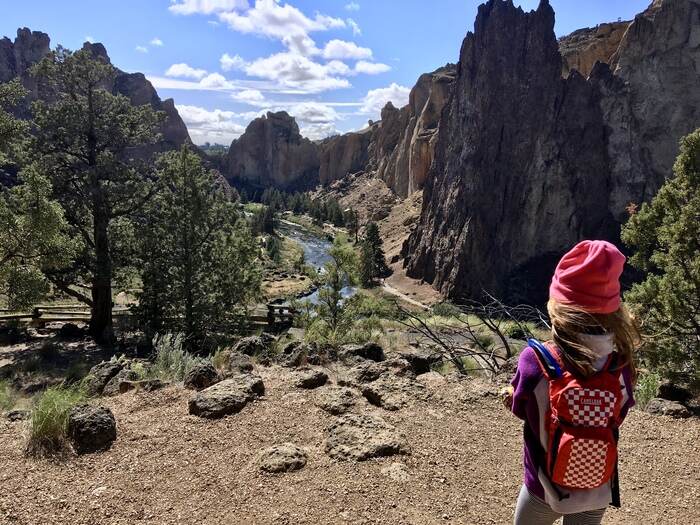 Child overlooking river and canyon at Smith Rock State Park in Oregon.