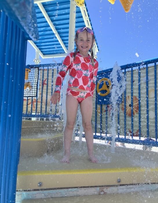 kid on a splashy play structure