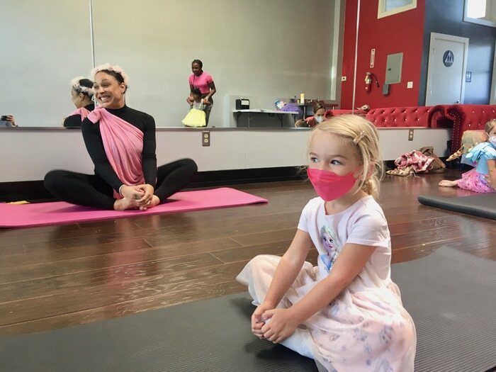 Child in yoga pose during class