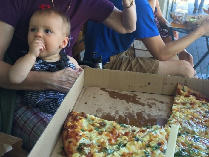 Baby eating cheeseboard pizza in Berkeley