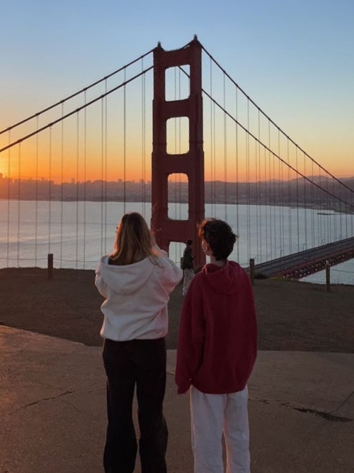 People watching sunrise over Golden Gate Bridge at Battery Spencer