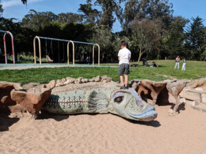 child climbs on a dragon sculpture