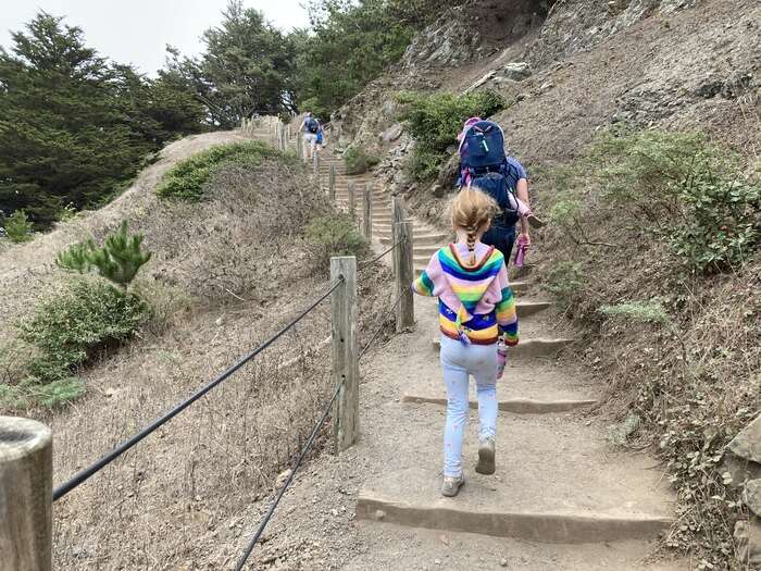 Family climbing stairs on hike in San Francisco