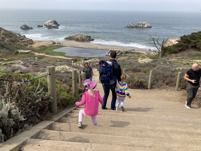 Family walks down stairs at Lands End