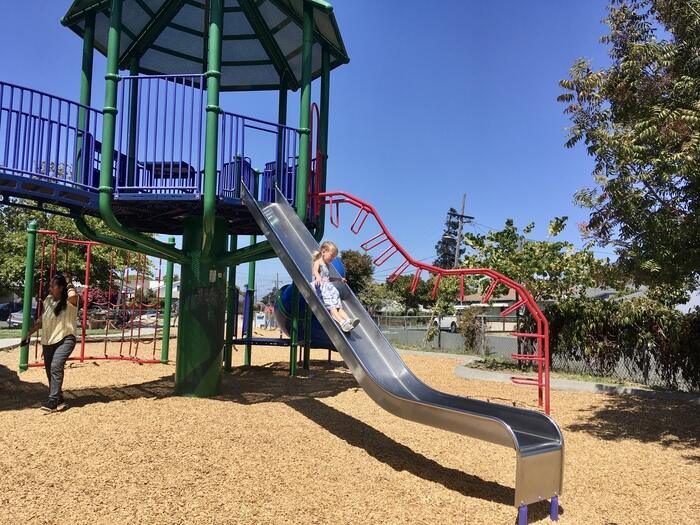 Child on slide at playground in Richmond