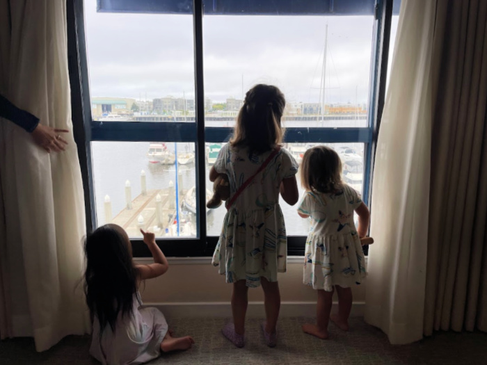 Visiting Oakland (Overnight!) With Kids 4 3 girls look out the window at the oakland marina