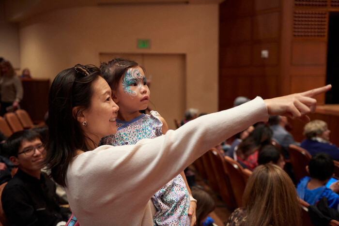 Best Christmas Traditions in San Francisco 5 mother holding child at concert