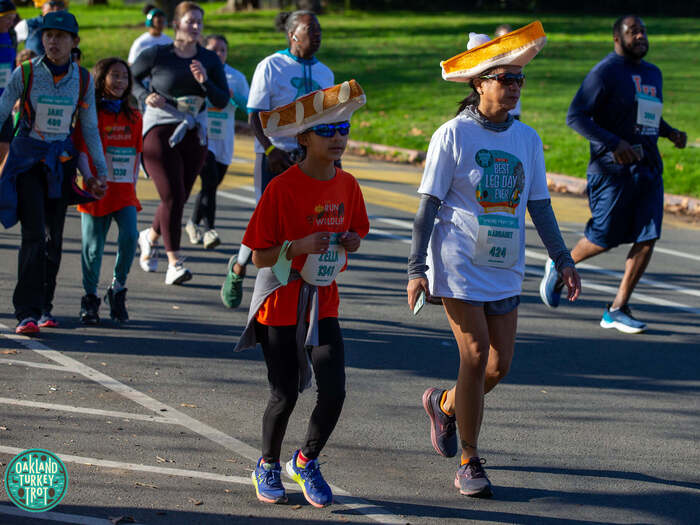 Mother and daughter run at Turkey Trot in Oakland