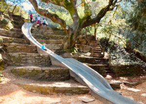 kid going down large slide