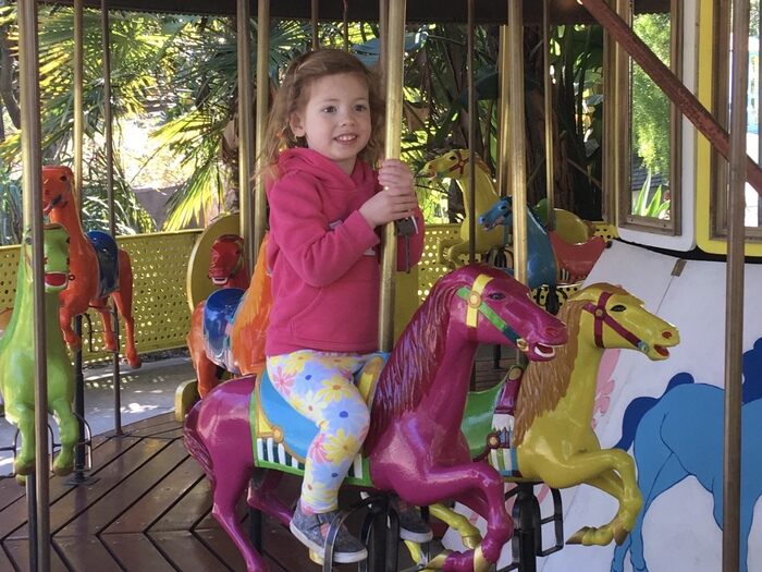 Child riding carousel at Children's Fairyland