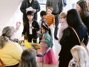 children playing xylophone with others looking on