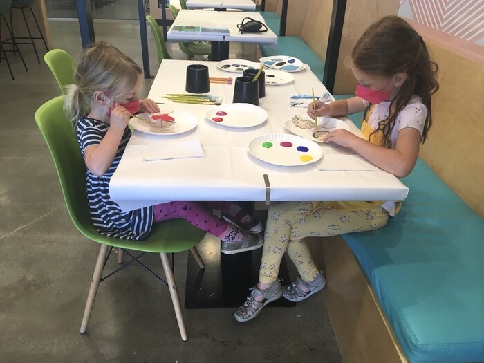 Children painting at table in art studio