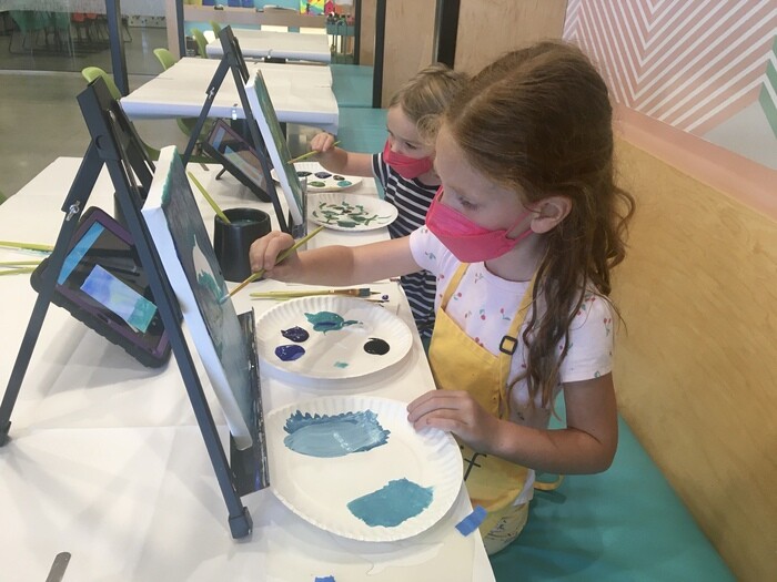 Children painting on canvas