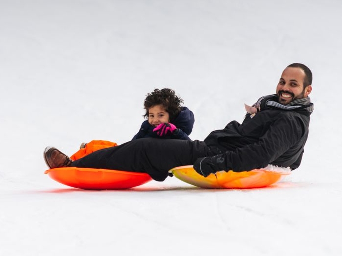 Father and child sledding at Granlibakken Ski and Sled Hill