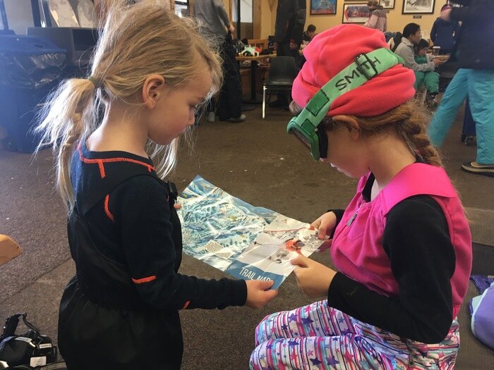 Children reviewing ski map