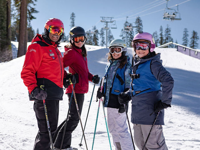 small group ski lesson with mixed ages in front of a ski lift at sierra at tahoe