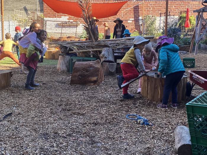 young kids play together in all weather outside