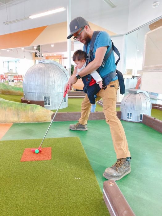 SubPar Mini Golf dad and baby putting