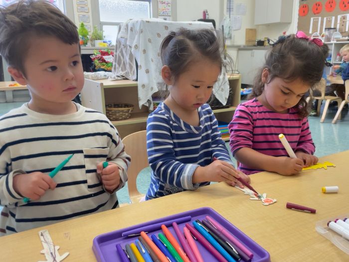 Pre K students coloring at EBI