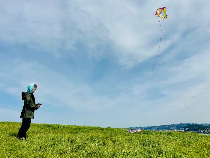 little kid flying kite