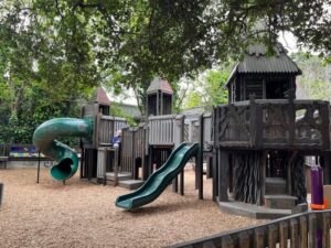 Wooden playground with slides and stairs