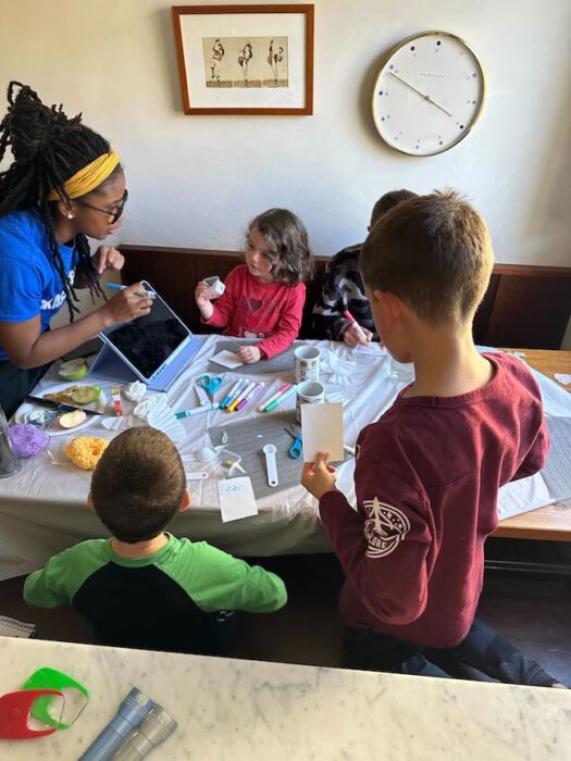 four kids and one teacher learning about food and science and fractions