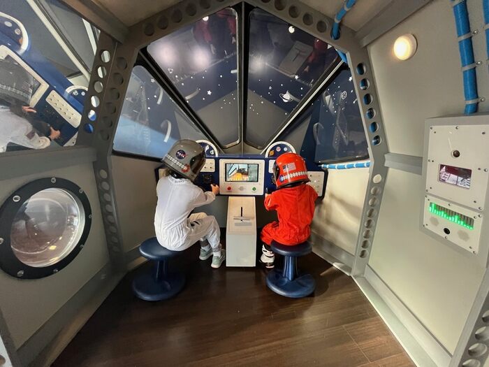 Children play in pretend spaceship 