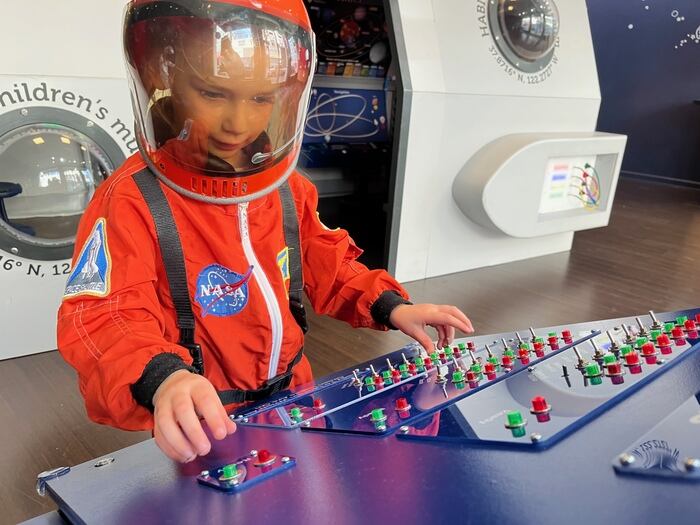 Child dressed in space suit at play