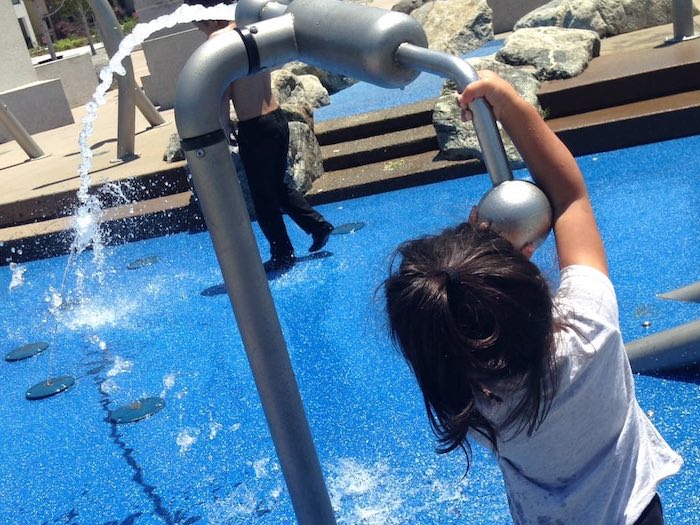 little kid at the spray ground at cannery park hayward